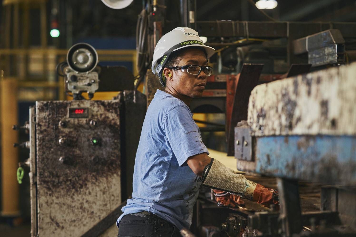 a worker in a factory working on a machine